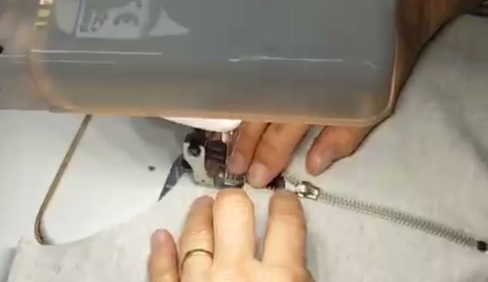 A zip being sewn during production in Portugal