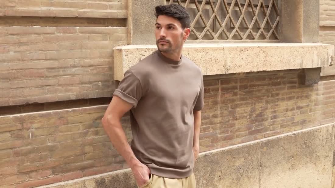 The same model with sleeves rolled and the Free Again print visible